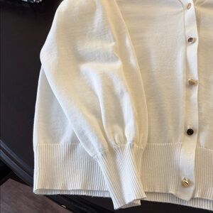 Elegant cream colored cardigan.  Beautiful gold buttons!